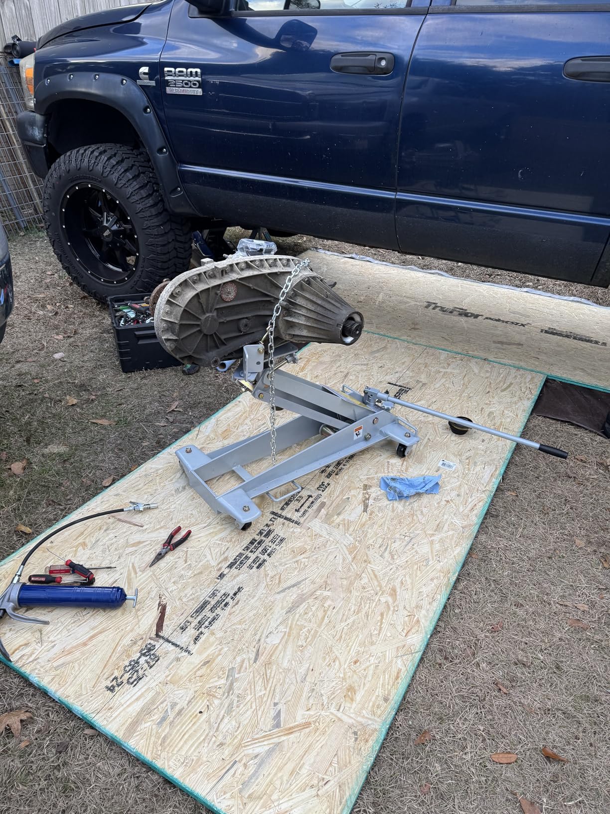 OTC 1521A 1000 Pound Capacity Low-Lift Transmission Jack - Features Tilting Universal Mounting Head w/ Adjustable Brackets, 6-1/2