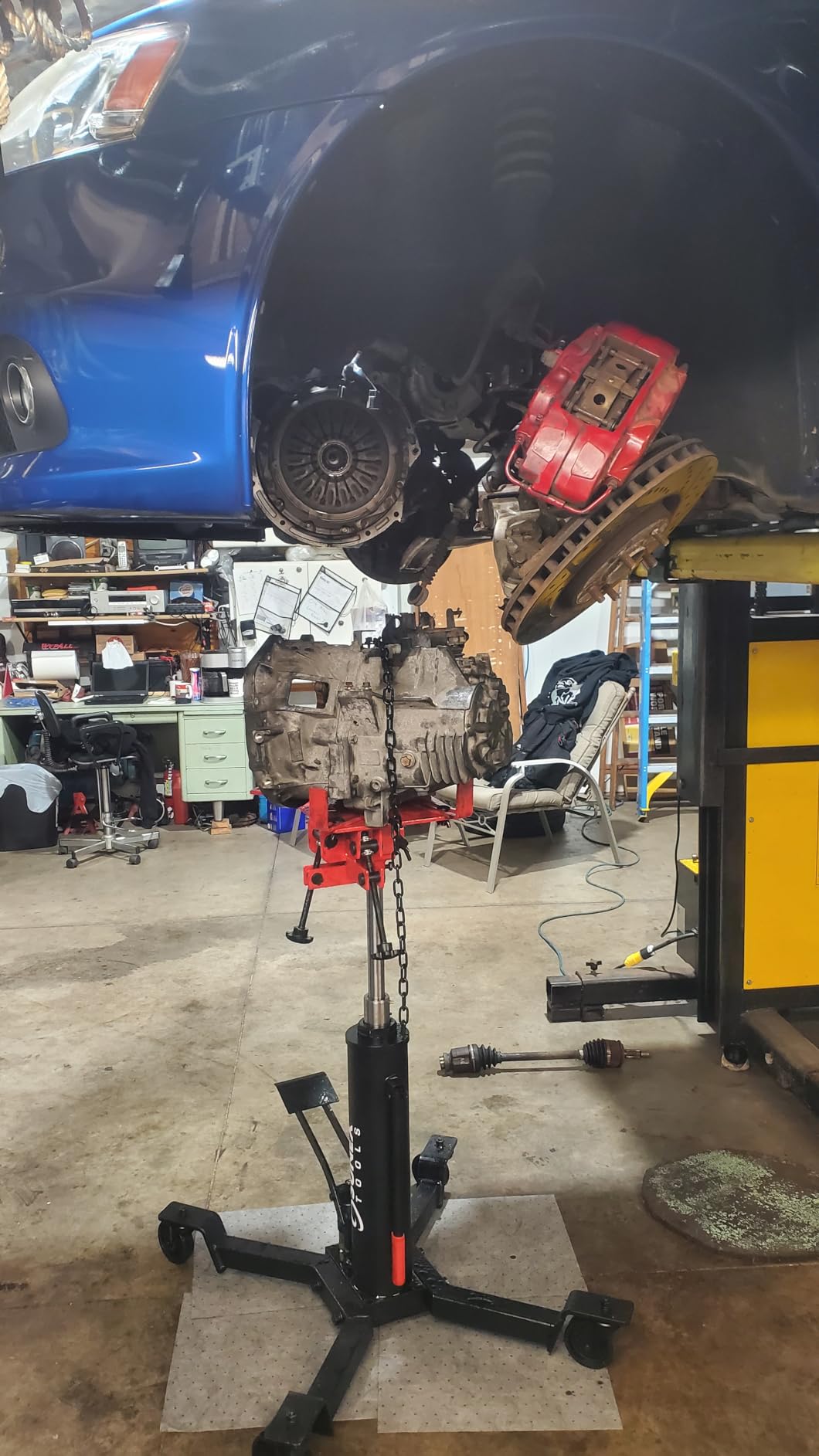 Sunex Tools 7793B 1,000 lb Telescopic Transmission Jack, Hydraulic, Foot Pump Operated, Tilt Saddle with Chain Tie-Down, 74.2 in Max Height customer photo 1
